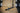 A black steel hammer extension placed on a wooden gym floor.