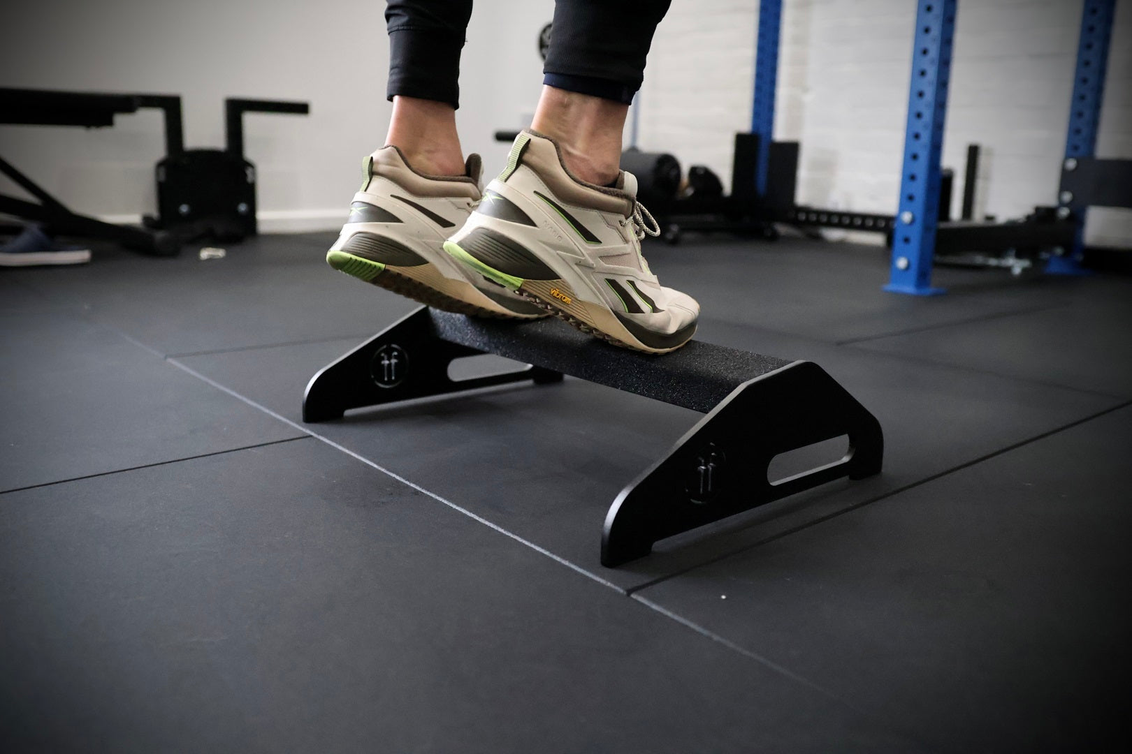 close up of a man doing calf raise on a calf raise platform