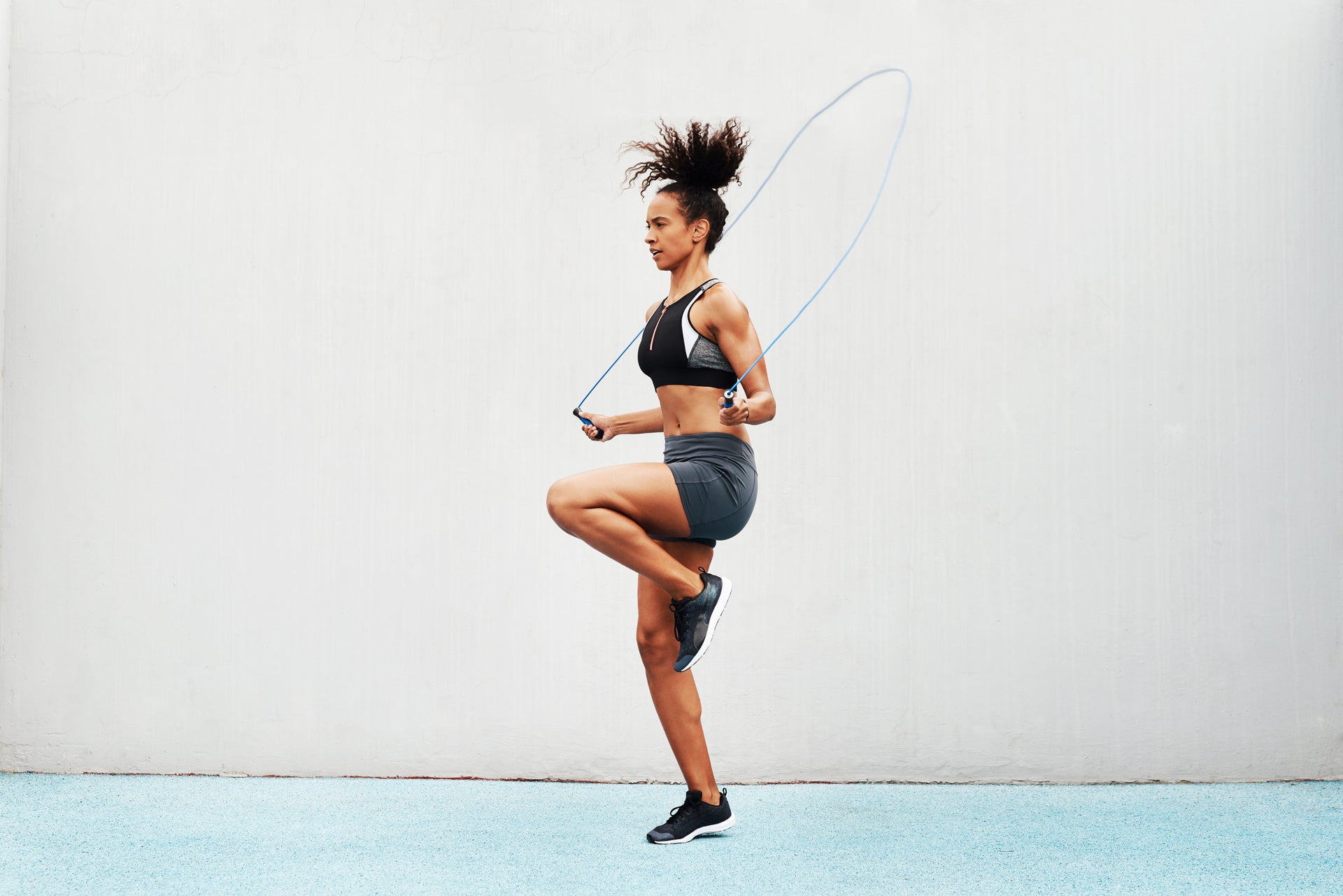 Full length shot of an attractive young athlete using a skipping rope during an outdoor training session