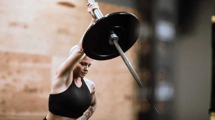 woman doing a landmine press